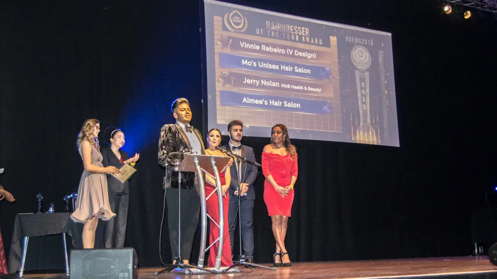 Finalists on stage as a category winner is announced on the big screen